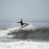 Photos: Surfers Take To Stormy Waves During NY Surf Week